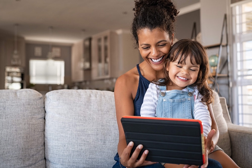 mother and daughter using tablet for education